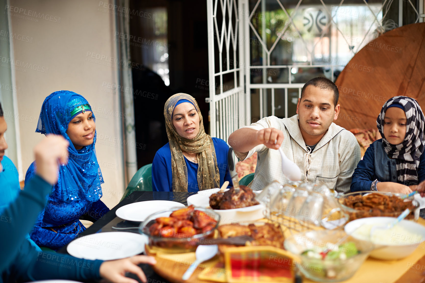 Buy stock photo Family, muslim and home in dinner for eid or ramadan on table for religion to enjoy and satisfied. Faith, Islam and feast in supper from fasting on religious outfit for meal and bonding together
