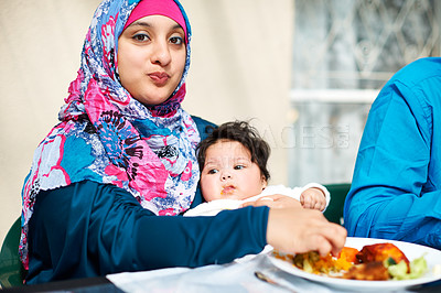 Buy stock photo Mom, baby and muslim in table for dinner with food for eid, ramadan and religion to enjoy at home. Faith, Islam and happy with meal or supper from fasting on religious outfit with feast and family. 