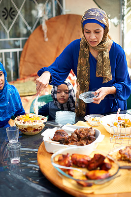 Buy stock photo Eid, holiday and family with food for muslim celebration with mother giving child a plate at table. Home, buffet and mom serving dish of dessert or meat with love and care on vacation for religion