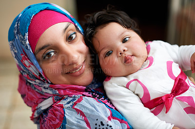 Buy stock photo Happy, portrait and muslim mom with baby in home with love and care for family in Saudi Arabia. Infant, child and Arabic mother relax in house with support and kindness of mama for kid in embrace