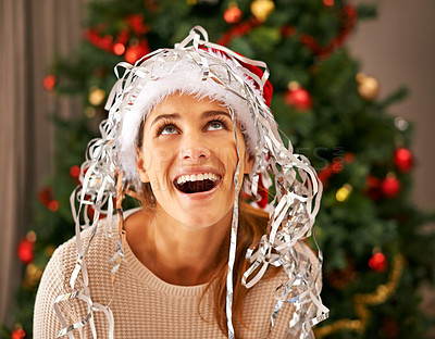 Buy stock photo Shot of a beautiful young woman enjoying a playful moment with Christmas decorations