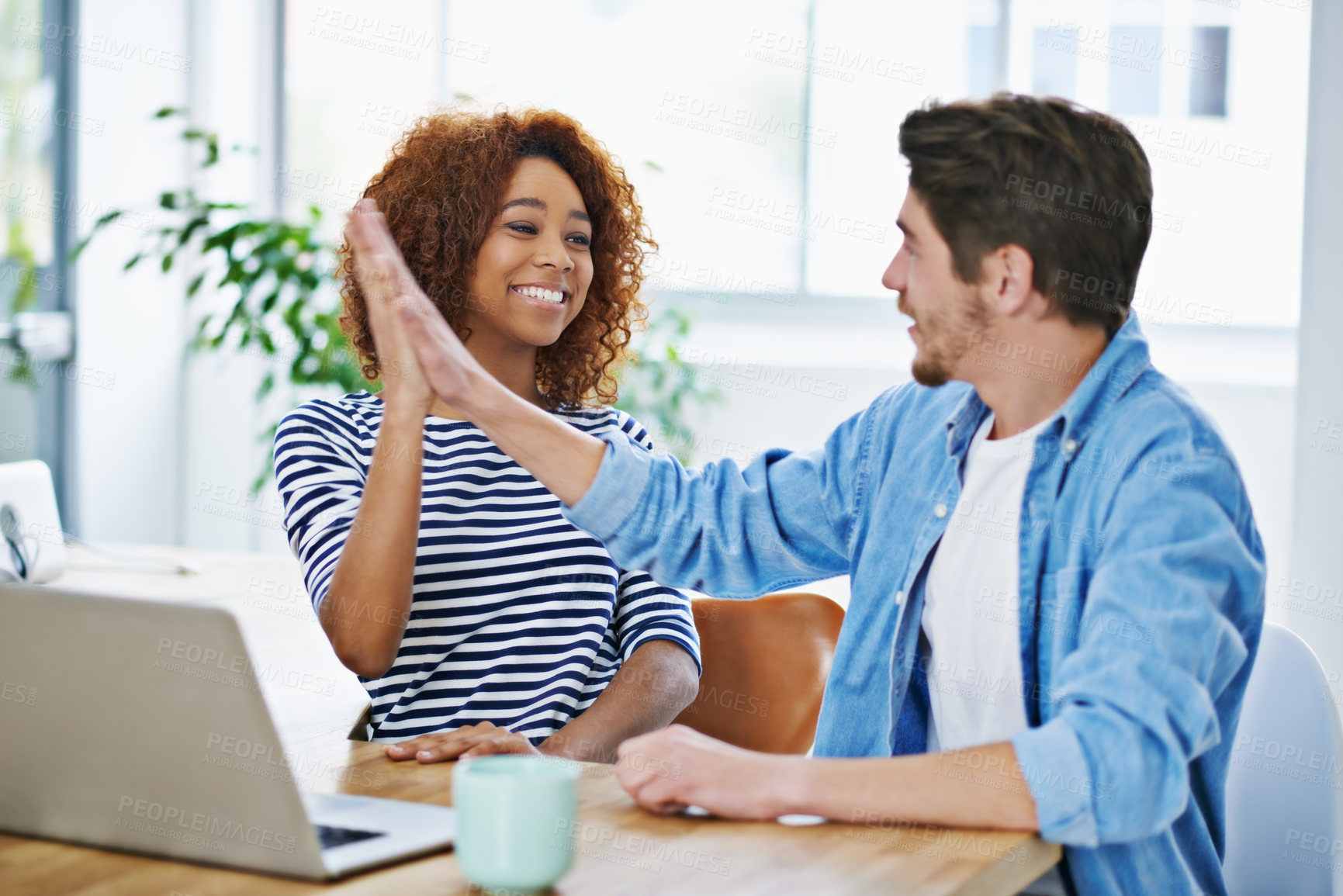 Buy stock photo Woman, high five and man with laptop in office for achievement, success and teamwork. Diverse employees, touching hands and happiness with technology for victory, accomplishment and goal review