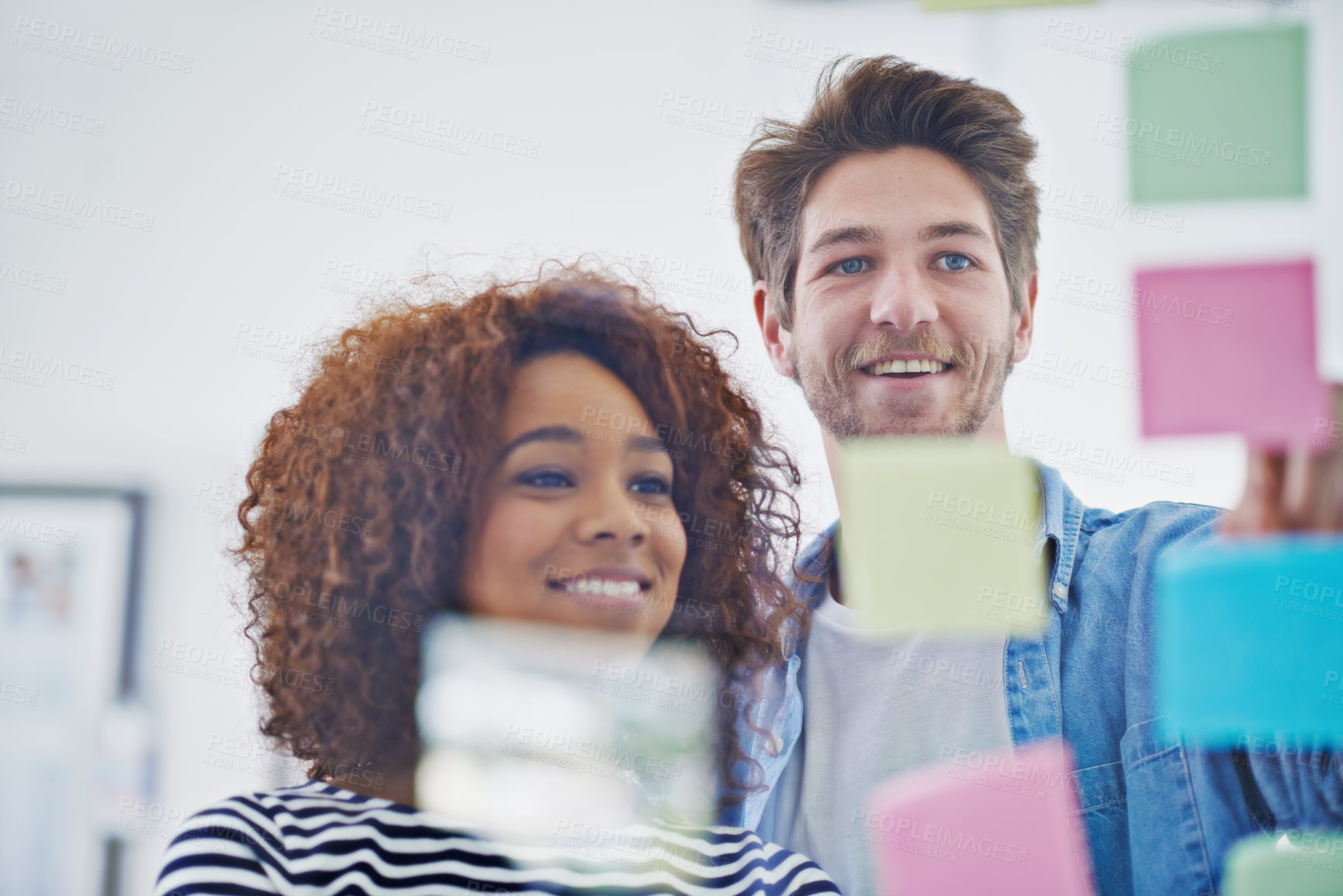 Buy stock photo Cropped shot of two colleagues working in their office