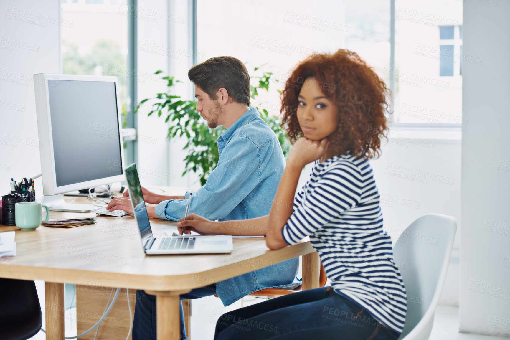 Buy stock photo Portrait, African woman and coworking on laptop at desk in an office, internet and work project. Diverse people, workstation and technology screen in workplace with online, business and partnership