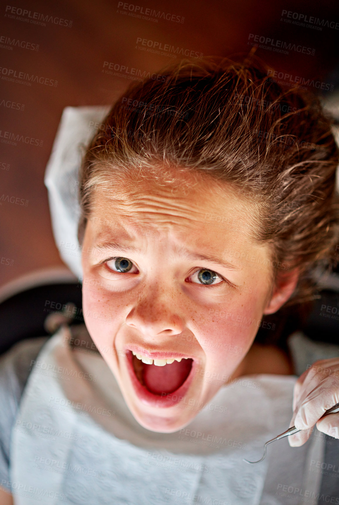 Buy stock photo Scared, child and portrait at dentist for teeth, cleaning and fear of healthcare at clinic or hospital. Dental, care and kid afraid of tools in mouth and scream for help in medical appointment