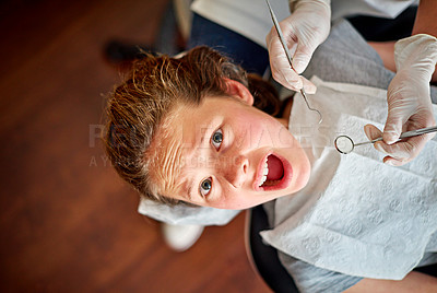 Buy stock photo Scared, kid and portrait at dentist for teeth, cleaning and fear of healthcare at clinic or hospital. Dental, care and child afraid of tools in mouth and scream for help in medical appointment