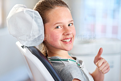 Buy stock photo Portrait of a young girl showing thumbs up while in the dentist's chair