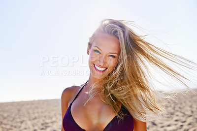 Buy stock photo Portrait of an attractive young blonde woman in a bikini relaxing at the beach