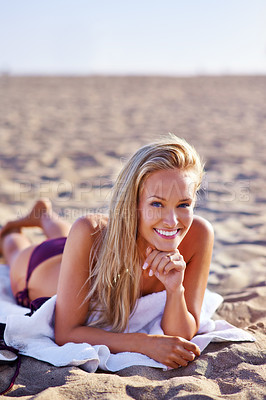 Buy stock photo Woman, swimwear and lying in towel at beach in summer or hot weather on holiday, break and rest in Miami. Portrait, female person and smile or happy on leisure with vacation to relax and chill.

