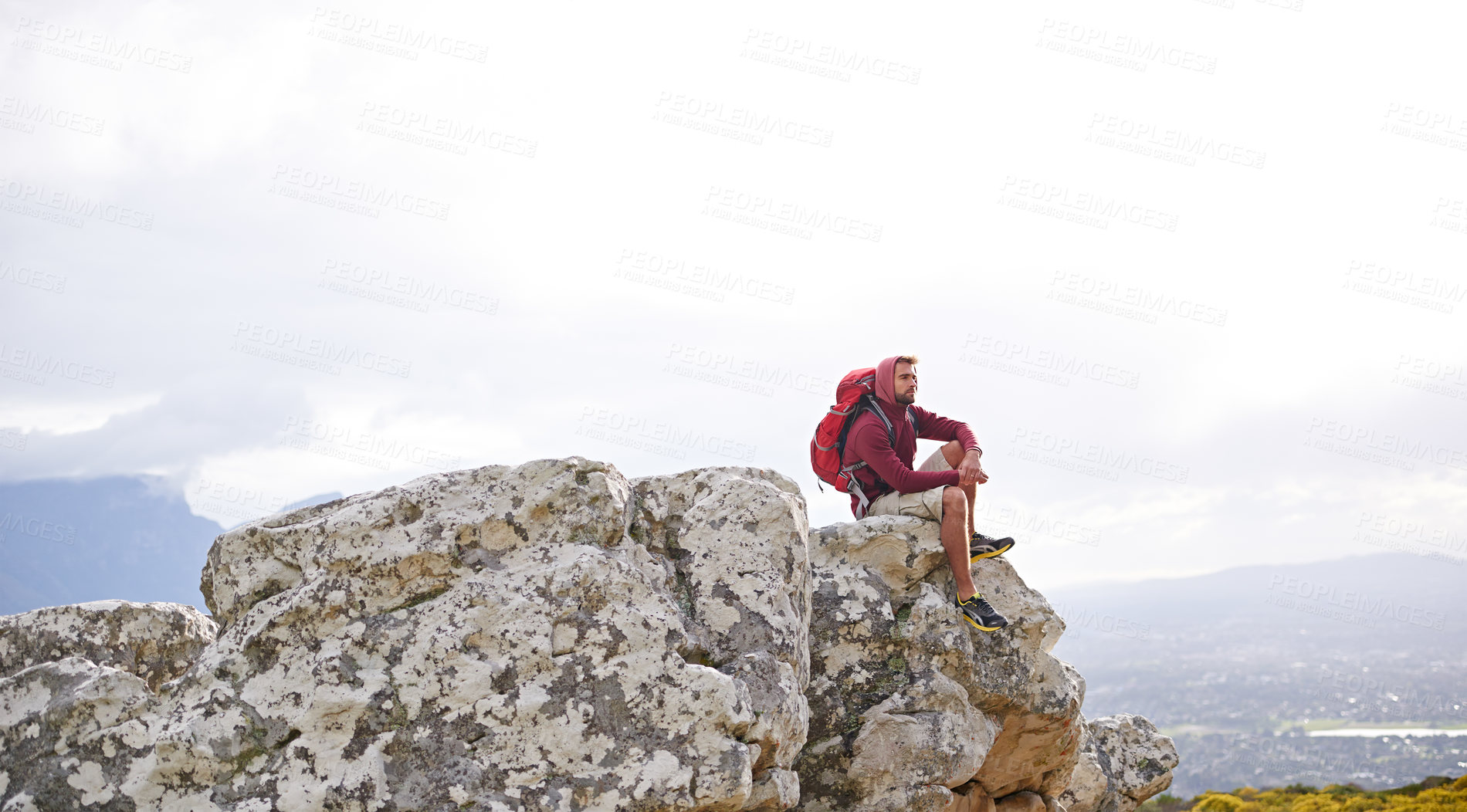 Buy stock photo Man, mountain and relax on outdoor hike in nature, workout and peace or calm on rocks for wellness. Male person, exercise and travel with backpack on vacation, adventure and explore bush for fitness