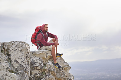 Buy stock photo Man, cliff and thoughts on outdoor hike in nature, mountain and peace or calm on rocks for wellness. Male person, exercise and travel with backpack on vacation, thinking and explore for fitness