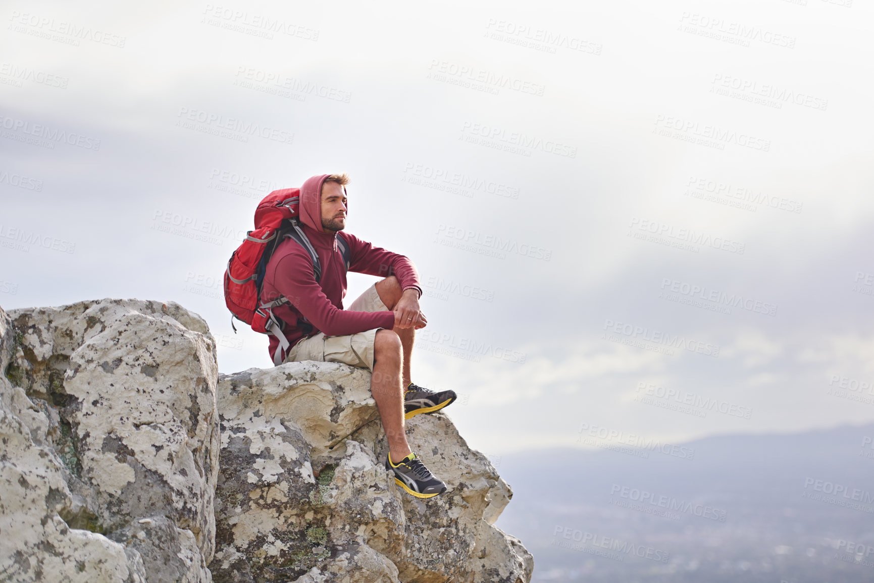 Buy stock photo Man, cliff and thoughts on outdoor hike in nature, mountain and peace or calm on rocks for wellness. Male person, exercise and travel with backpack on vacation, thinking and explore for fitness