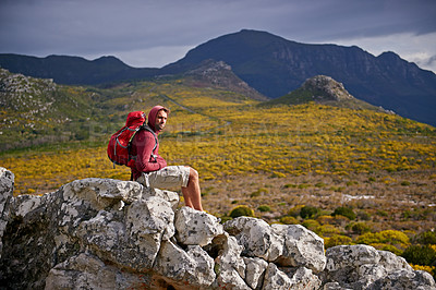 Buy stock photo Man, rocks and relax on outdoor hike in nature, solitude and peace or calm on rocks for wellness. Male person, exercise and travel with backpack on vacation, adventure and explore bush for fitness