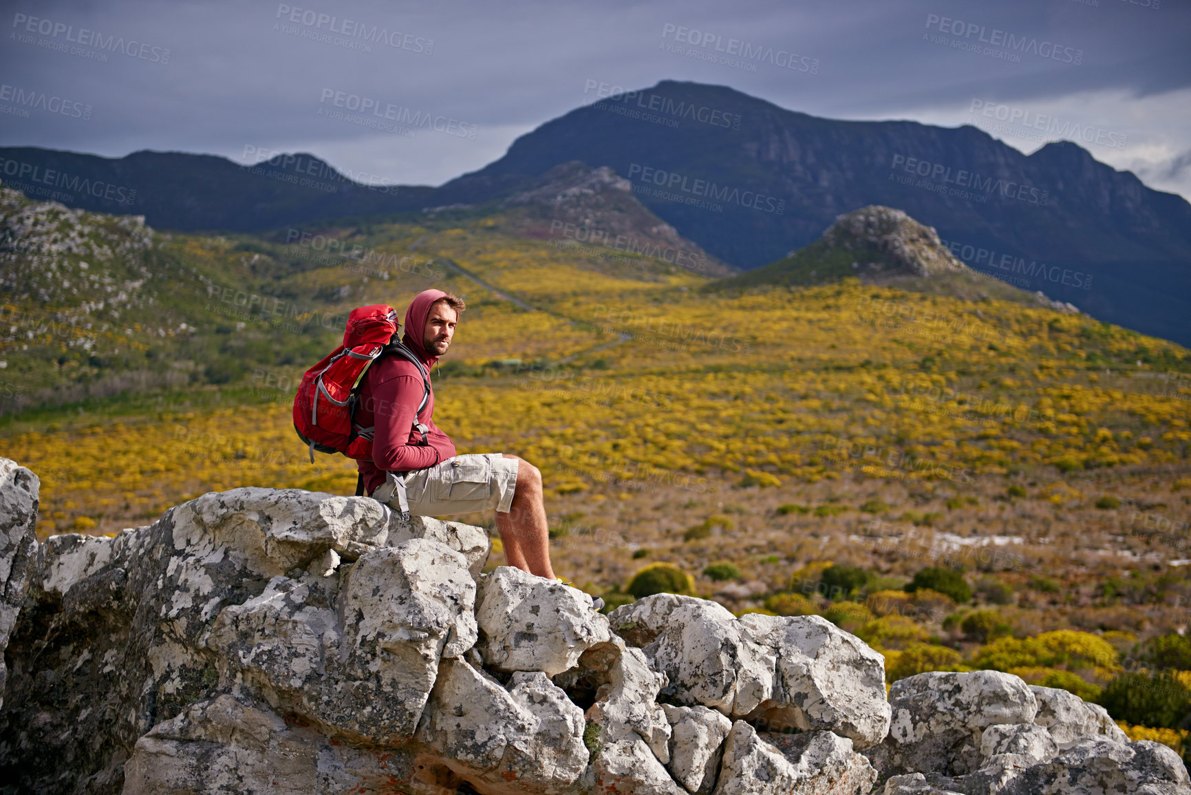 Buy stock photo Man, rocks and relax on outdoor hike in nature, solitude and peace or calm on rocks for wellness. Male person, exercise and travel with backpack on vacation, adventure and explore bush for fitness