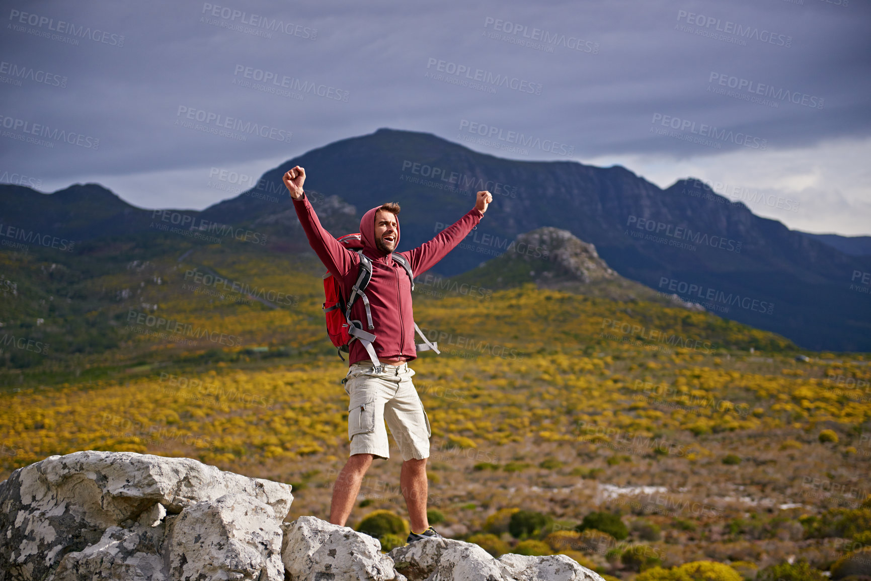 Buy stock photo Happy, mountain and man with celebration for hiking, peak and journey with success and freedom outdoor. Trekking, rock climbing and horizon with arms raised for achievement, travel and adventure