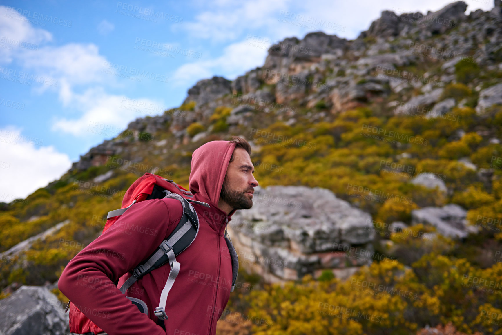 Buy stock photo Man, hiking and workout in outdoor nature, mountain and peace or calm on rocks for wellness. Male person, exercise and travel with backpack on vacation, adventure and explore for fitness or trekking