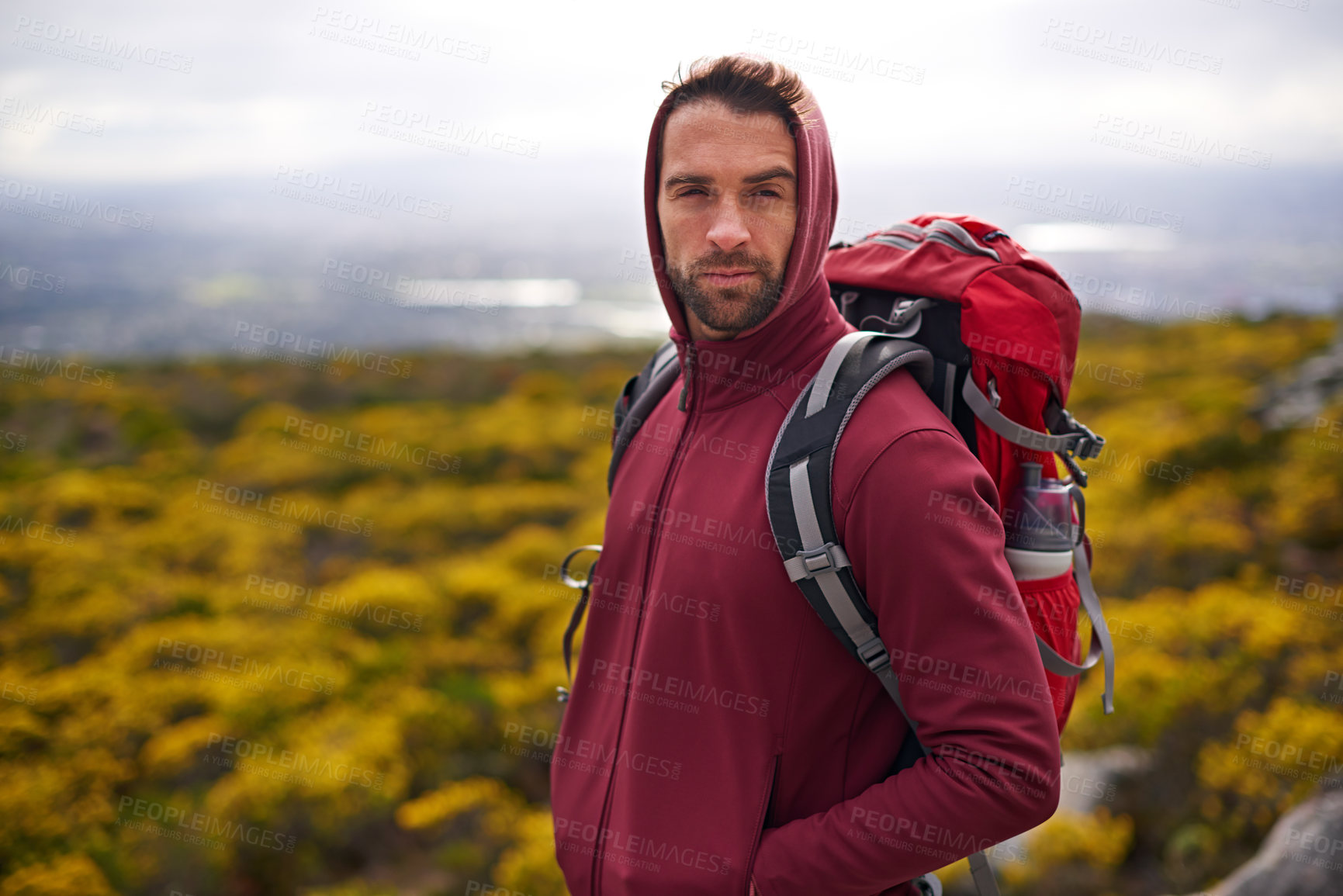 Buy stock photo Hiking, serious and face of man on mountain, nature and rock for outdoor adventure with vision. Male person, athlete or sport in environment for exercise, fitness or health with backpack by landscape