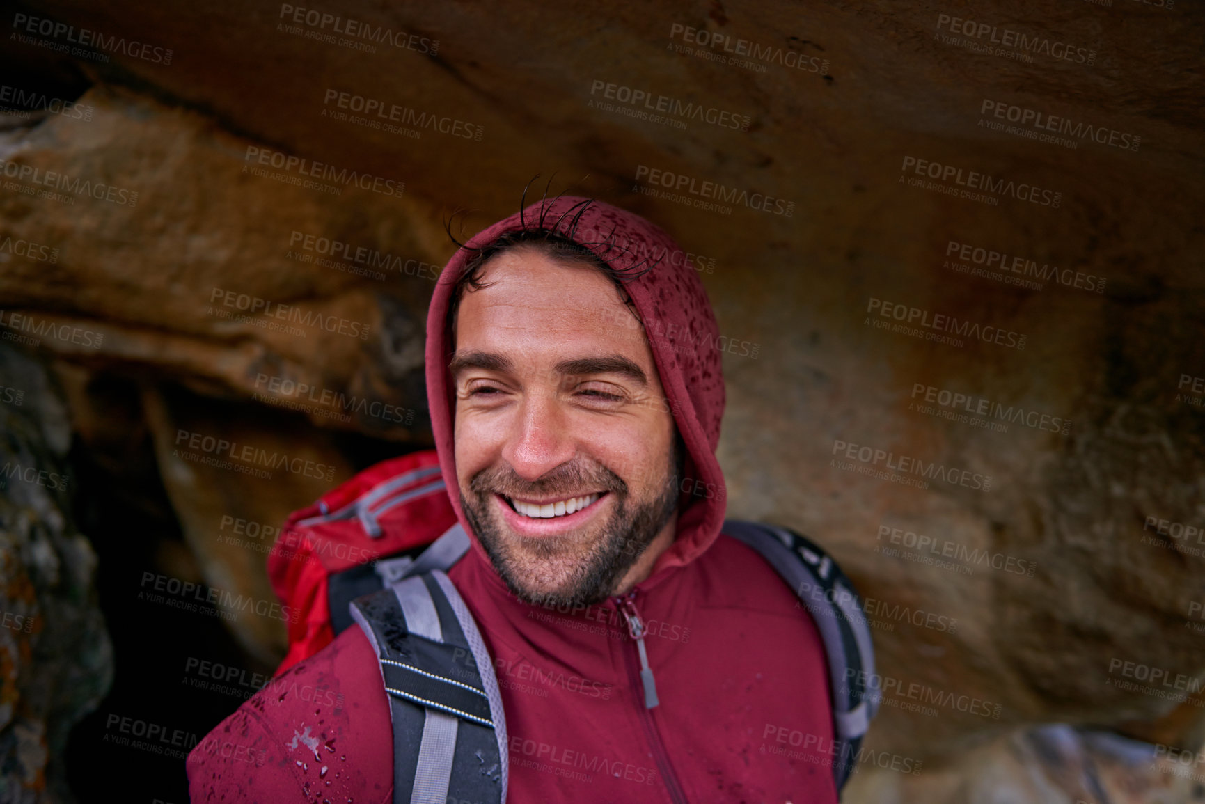 Buy stock photo Cave, smile and man hiking in mountain, nature and vacation in holiday, wellness and health. Travel, trekking and male person with pride, happiness and adventure of guy with backpack in trip