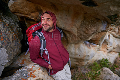 Buy stock photo Nature, cave and man with smile, backpack and happiness in mountain or rock for adventure and freedom. Hiking, earth and male person with climbing for travel, stone and environment and outdoor