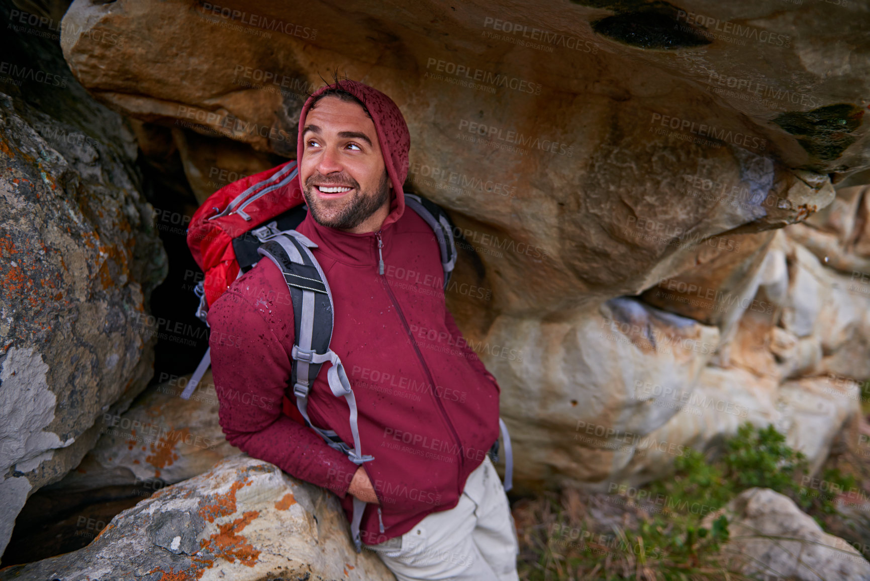 Buy stock photo Nature, cave and man with smile, backpack and happiness in mountain or rock for adventure and freedom. Hiking, earth and male person with climbing for travel, stone and environment and outdoor