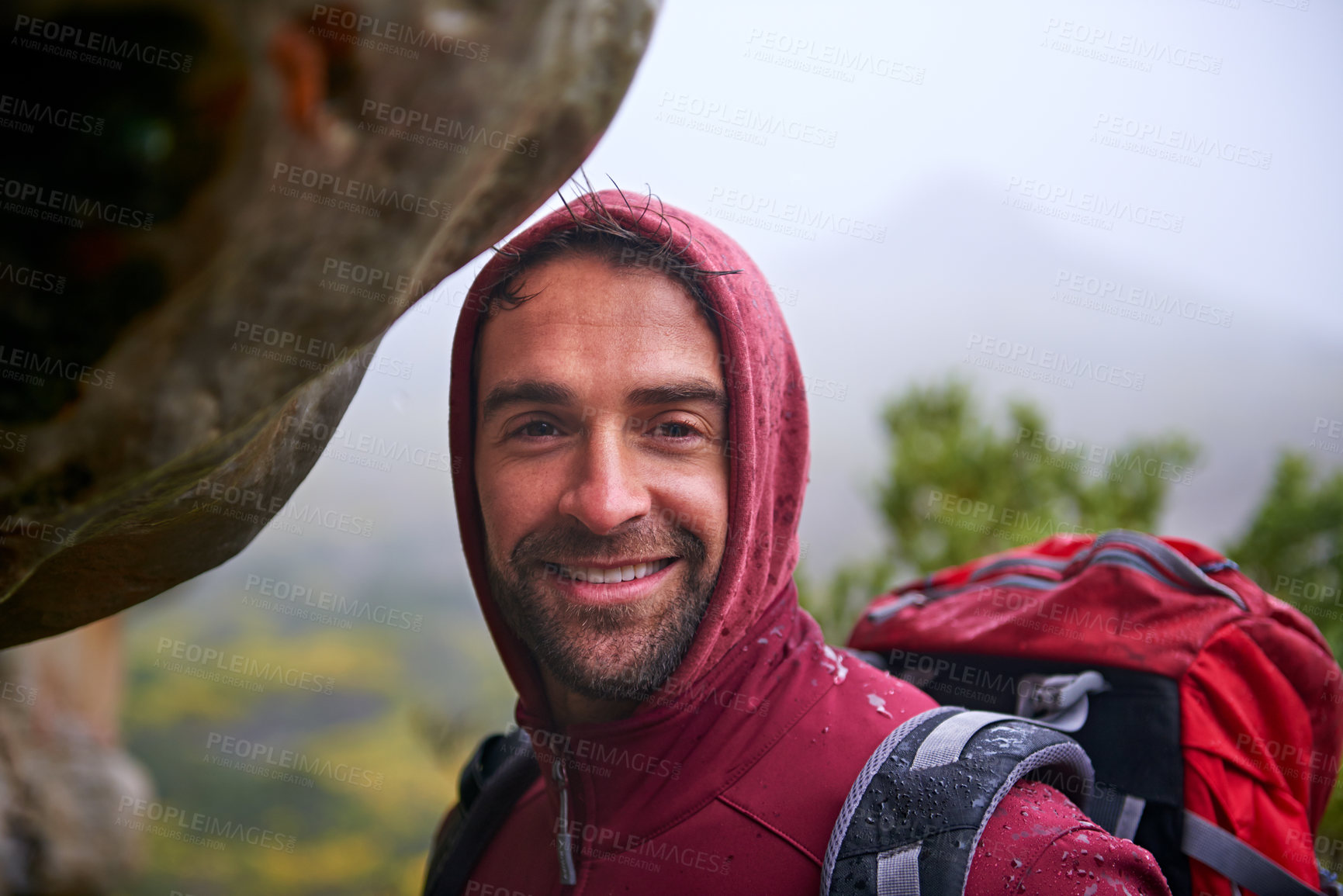 Buy stock photo Shot of a young man enjoying a hike through the mountains