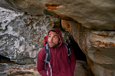 Buy stock photo Nature, explore and man in cave, backpack and trekking in mountain or rock for adventure. Hiking, earth and male person with discover for travel, stone, environment and outdoor sport for holiday