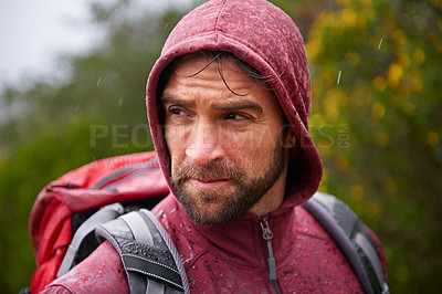 Buy stock photo Nature, trekking and man with backpack in rain, hoodie and walking on landscape, fresh air and wellness. Forest, travel or hiking of male person for exercise, health or camping for holiday and trip