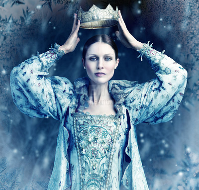 Buy stock photo Shot of queen holding a crown over her head with snow falling around her