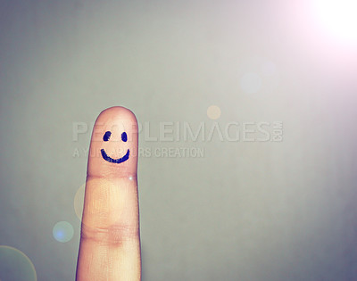 Buy stock photo Shot of a finger with a happy face drawn on it