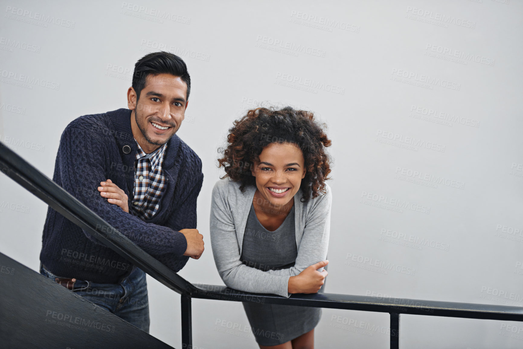 Buy stock photo Employees, relax and portrait on stairs in office with happiness, pride and confidence in workplace. Business, people and smile with friends on calm break at work with staff together on railing