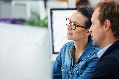Buy stock photo Cropped shot of two colleagues working in the office