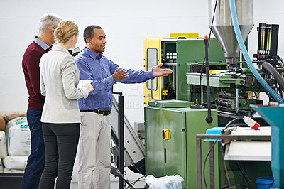 Buy stock photo Shot of a managers inspecting factory machinery