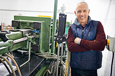 Buy stock photo Portrait of a mature man standing next to machinery in a factory