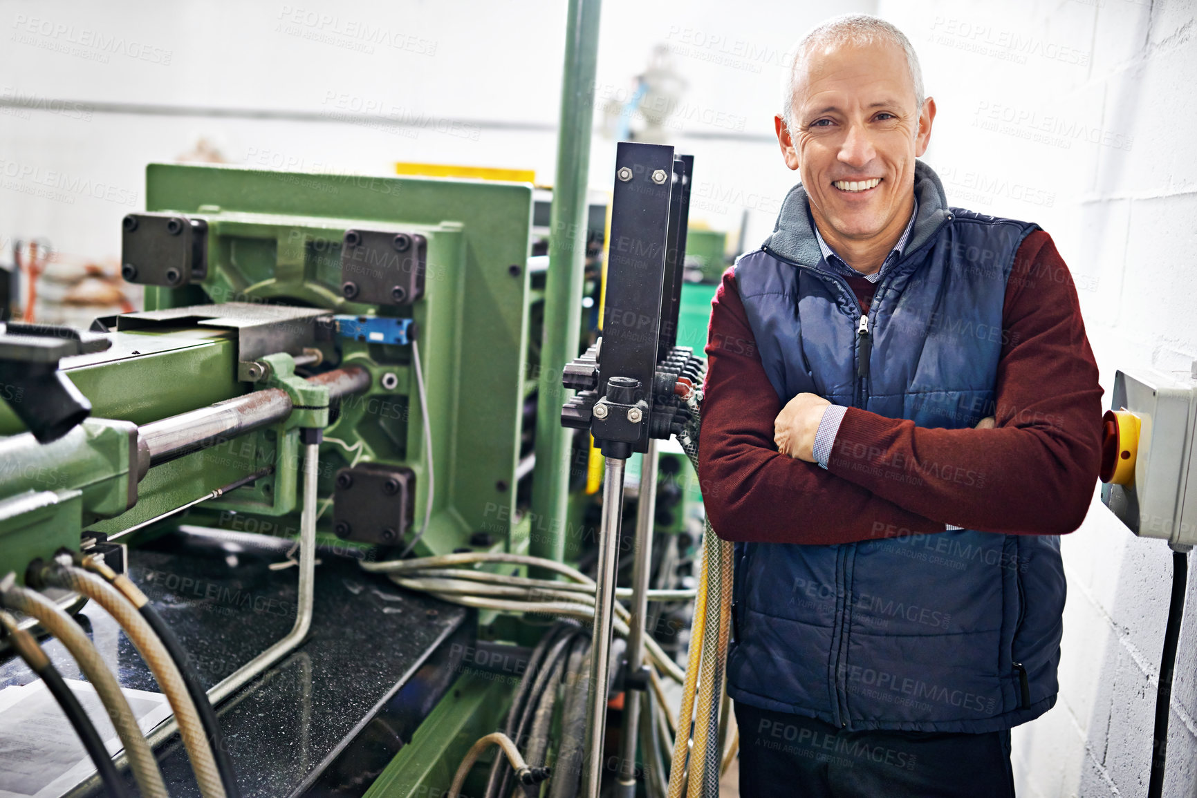 Buy stock photo Portrait of a mature man standing next to machinery in a factory