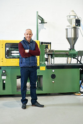 Buy stock photo Full length portrait of a mature man standing next to machinery in a factory