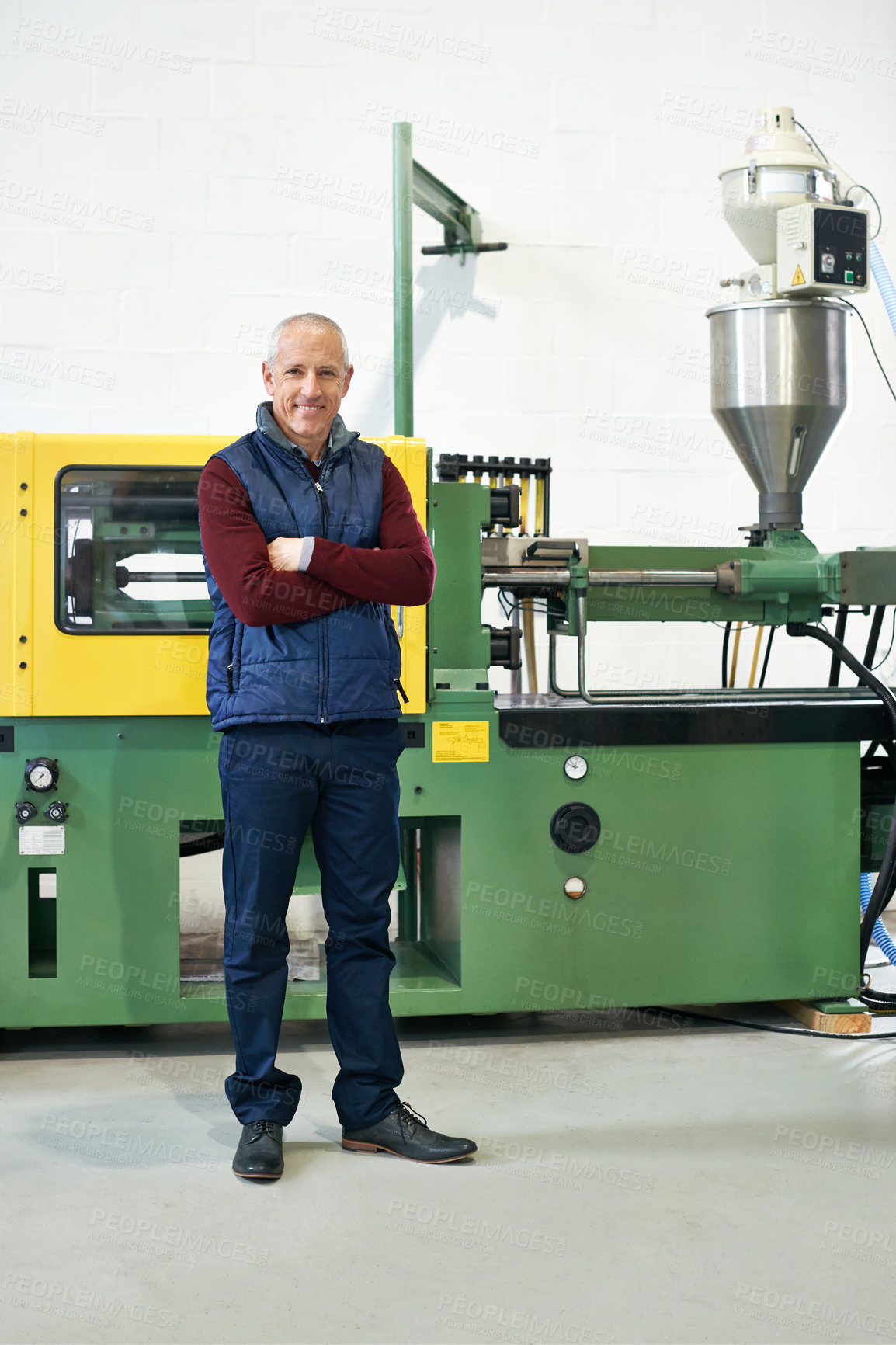 Buy stock photo Full length portrait of a mature man standing next to machinery in a factory