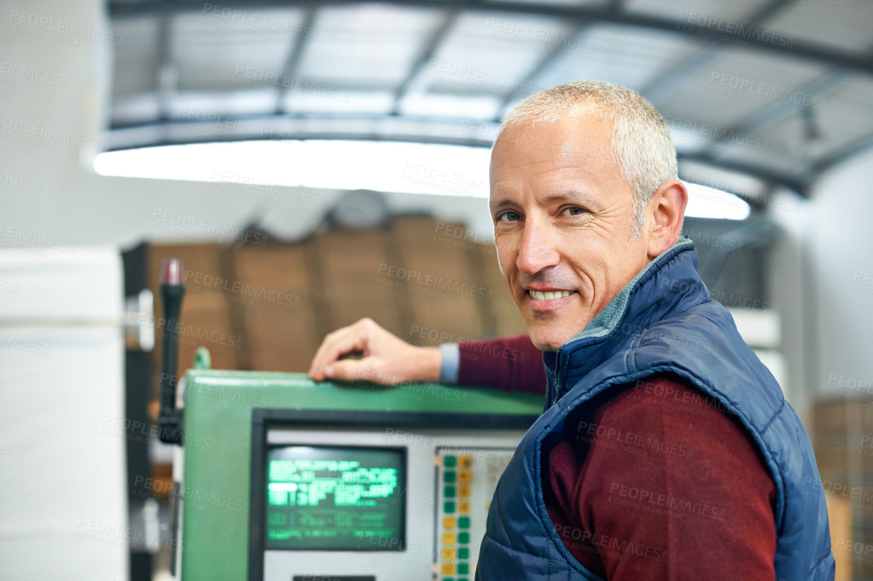 Buy stock photo Portrait of a mature man standing next to machinery in a factory