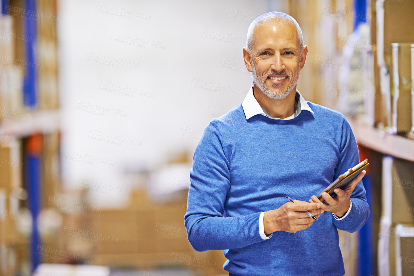 Buy stock photo Portrait of a mature man working inside in a distribution warehouse