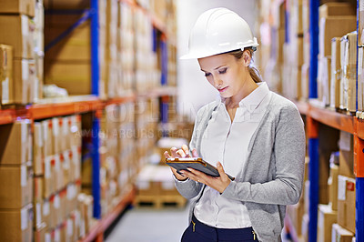 Buy stock photo Shot of a woman at work in a storage warehouse