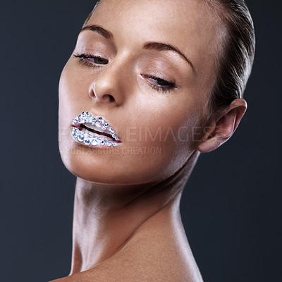 Buy stock photo Beauty, face and woman with crystal on lips in studio with jewelry isolated on black background. Diamond, sparkle and model with creative makeup for skincare, cosmetics or art for aesthetic lipstick