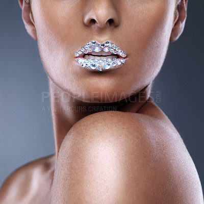Buy stock photo Beauty, teeth and woman with diamond on lips in studio isolated on a grey background. Face, mouth and sparkle of model with creative makeup for skincare, cosmetics and art for aesthetic with crystal