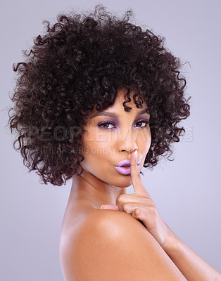 Buy stock photo Studio, beauty and secret for African woman, face and cosmetic on white background. Lipstick, portrait and sign for quiet with afro curly hairstyle for female model, cosmetology or skincare or makeup