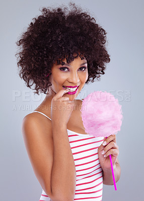 Buy stock photo Beauty, portrait and cotton candy for female person, studio and makeup on white background. Sweet treat, cosmetic or bite finger in mouth of African woman model with afro, flirty or playful smile