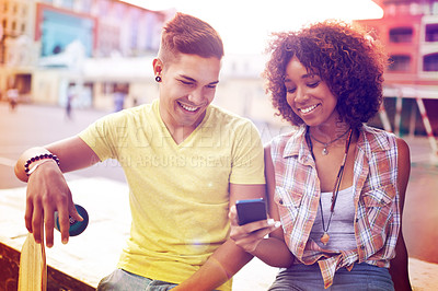 Buy stock photo Interracial couple, skatepark and smartphone for online post, social media or communication in city. Skateboard, happy man and woman with mobile phone for memories, weekend trip and networking