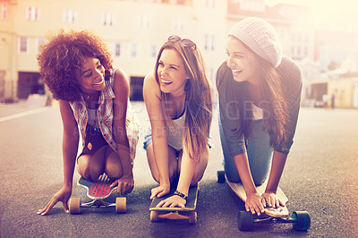 Buy stock photo Skatepark, laugh and friends in street for balance, hobby or competition in city. Skater, lens flare and diverse group of women with skateboard for training, exercise or happiness in outdoor activity