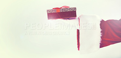 Buy stock photo Santa claus, hand and christmas gift, box and festive holiday, celebration and ribbon in mockup white studio background. Man hands, present and giving package, surprise and in red costume in mock up