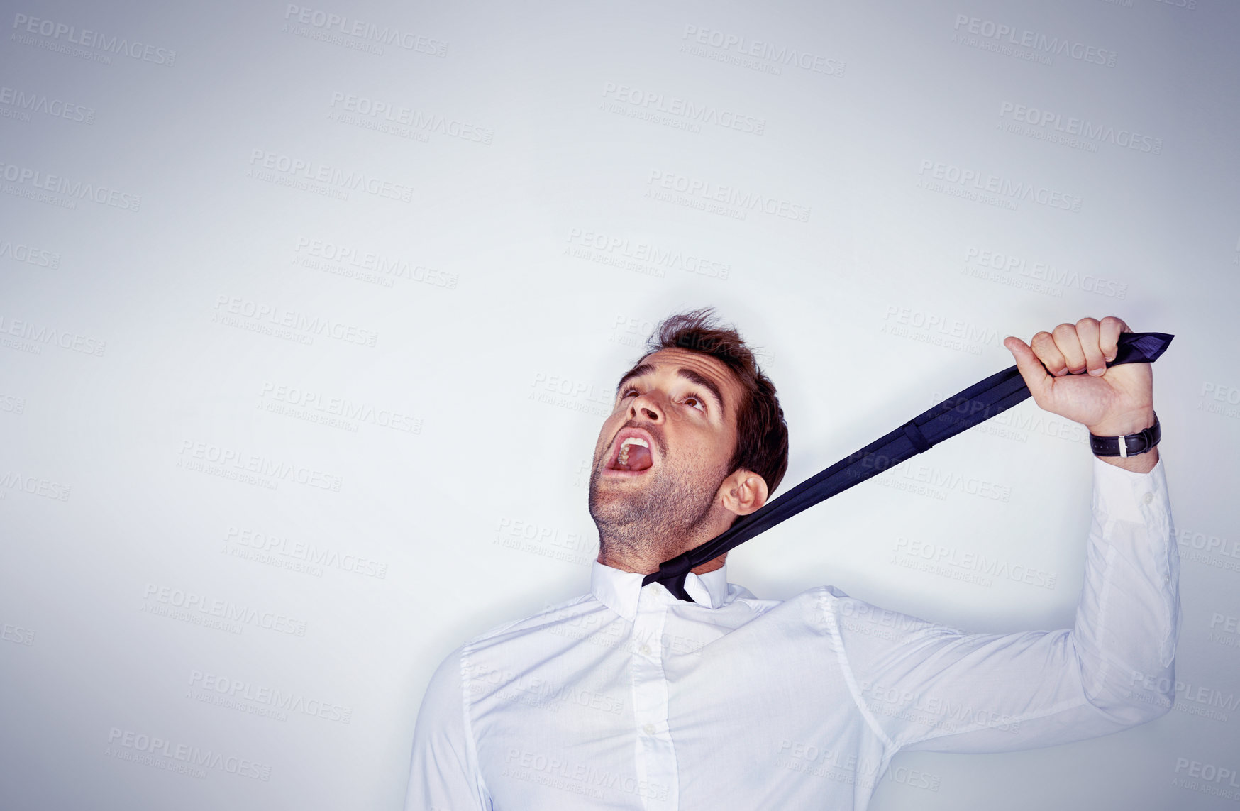 Buy stock photo Stress, mental health and a man choking on his tie in studio on a white background with mockup space. Depression, anxiety and strangle for self harm with an unhappy young person shouting in anger