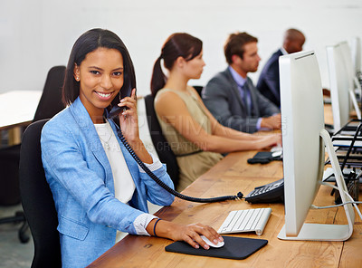 Buy stock photo Portrait of an attractive young woman answering the phone with her colleagues in the background