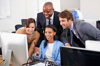 Buy stock photo Shot of a group of businesspeople working around a computer