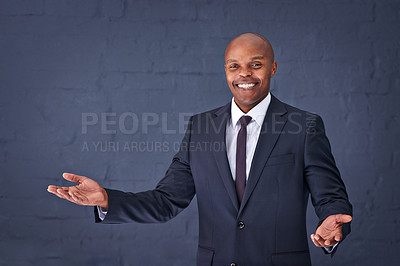 Buy stock photo Happy, portrait and black man with palm for presentation, speech or advertising on a gray studio background. African male person, businessman or speaker with smile for communication on mockup space